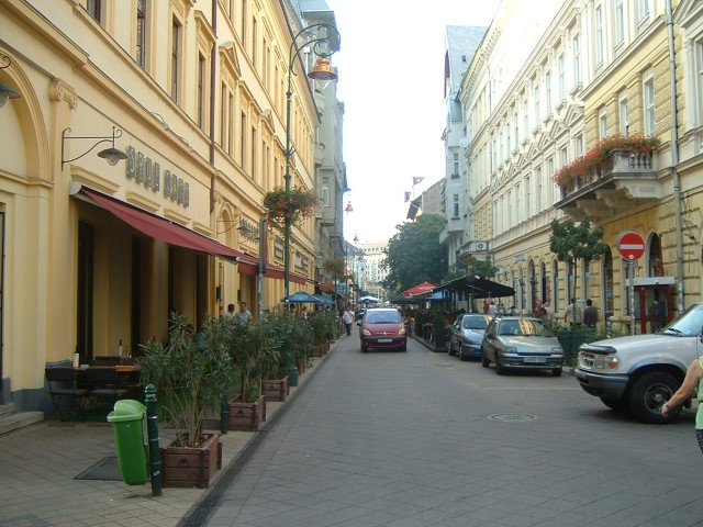 A pleasant stree of pavement cafs in Pest.