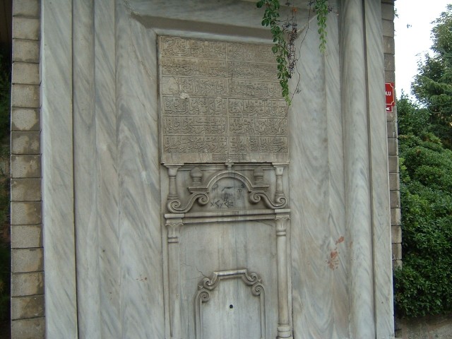 A monument next to <i>Million</i>, bearing some unusual graffiti: "m<sup>2</sup> = m<sup>3</sup...
