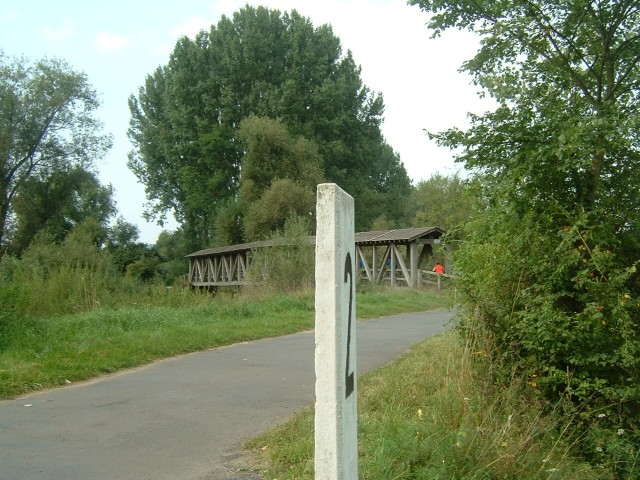 A covered bridge on the Rhein cycleway. The number 2 in the foreground is one the the markers which ...