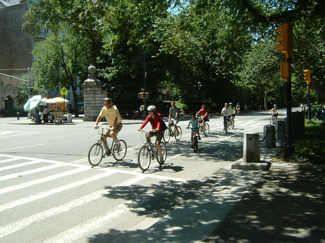 Part of a large group of cyclists who are just setting off. So far, they are mostly in the proper la...