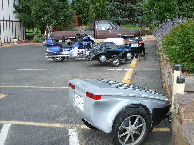 There are some motorcyclists staying here. I like the trailer which looks like a small car.