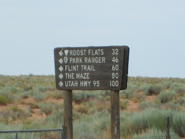 This sign pointed down a dirt track. I certainly wouldn't do 100 miles on a track like that.