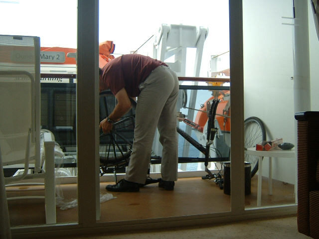 Re-assembling my bike. I hope nobody objects to me wheeling something this size off the ship, and th...