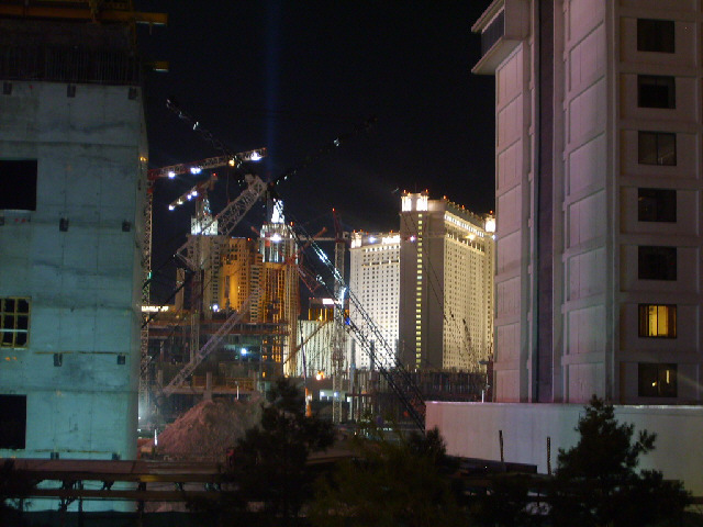 Betyond the cranes, you can see the beam of light from the Luxor Hotel pointing up into the sky.