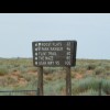 This sign pointed down a dirt track. I certainly wouldn't do 100 miles on a track like that.