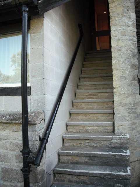 Here's an efficient use of building materials: the drainpipe is also a handrail.
