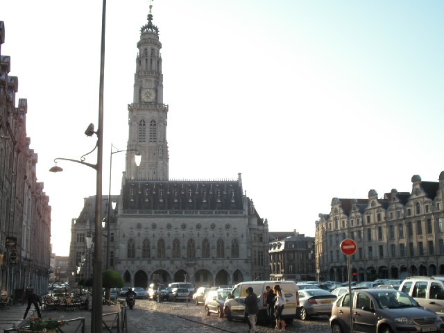 The Place des Hros in Arras. After the rain, it's turned into a sunny, cloudless evening. The forec...