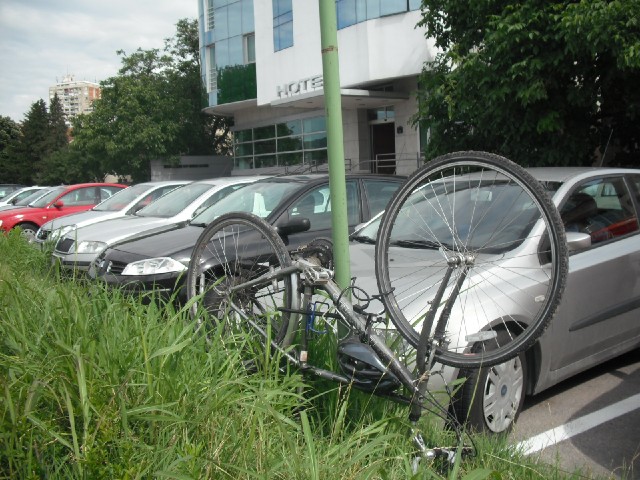 My bike sporting its new lock, parked upside-down to prevent it falling onto the cars. The hotel lat...