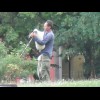 A man playing the bagpipes in the park.