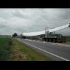 Three blades of a wind turbine being transported.<br><br>The bike's still broken.
