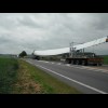 Three blades of a wind turbine being transported.<br><br>The bike's still broken.