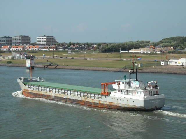 A ship heading out to sea.