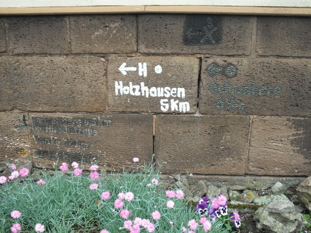 It looks like this wall has been used for several tiny distance markers in the past.
