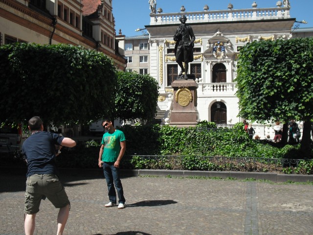 Tourists in front of a statue of Goethe in front of the Old Stock Exchange.