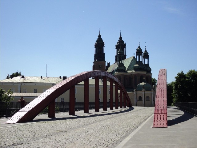 The Archcathedral Basilica of St. Peter and St. Paul with a bridge for pedestrians and cyclists over...