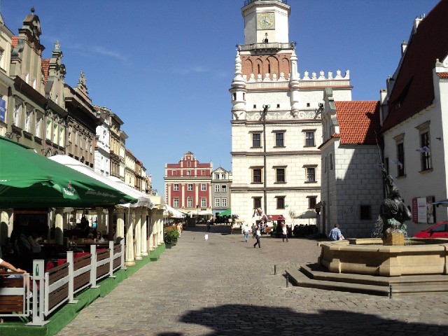 In the bar on the left, and others around the square, people are taking their places in front of the...