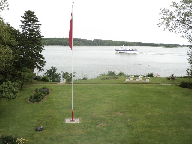 The ferry from the island of r chugs past my window while a robot mows the hotel's lawn.