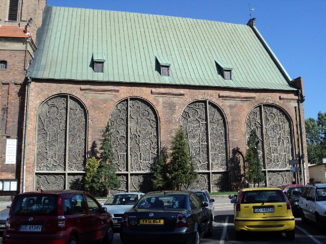Big stained glass windows on that church. The car in the middle is one of many British cars I have s...