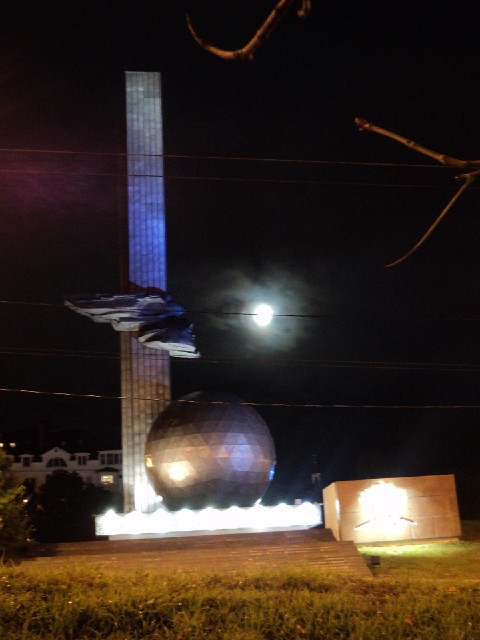 A sculpture in Kaluga, with the moon behind it.