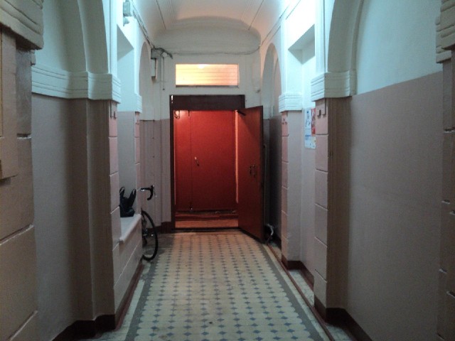 The hallway of the apartment block doesn't live up to the standard of the apartment's interior.
