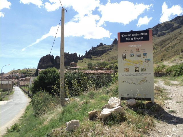 The Camino goes up across the fields just to the left of the sign.