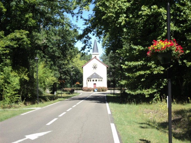 This church is in the middle of the road.