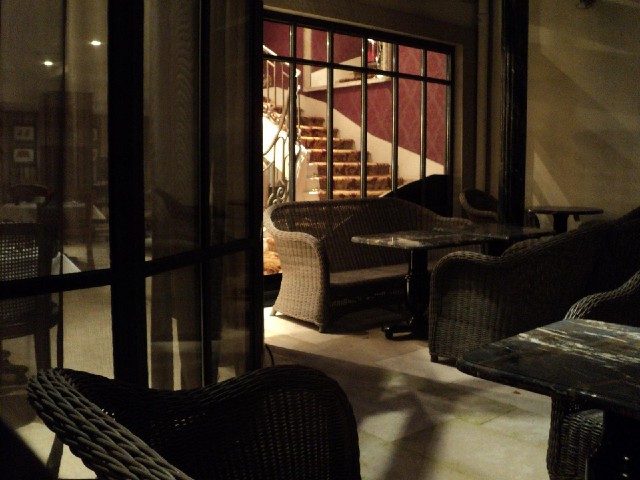 The view from my window is of the hotel's outside seating area and the stairs which lead up to stree...
