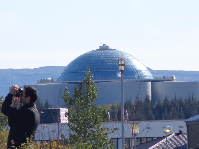 The big cyclinders are the city's hot water storage tanks. The dome on top is called the Pearl and c...