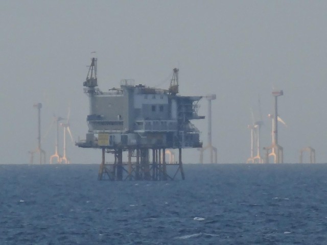 Drilling platform GNSC-H-7 with a wind farm, or possibly two, behind it.