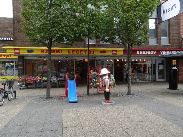 I like how there's a big Lego man outside the toy shop and a big bottle of wine outside the wine sho...