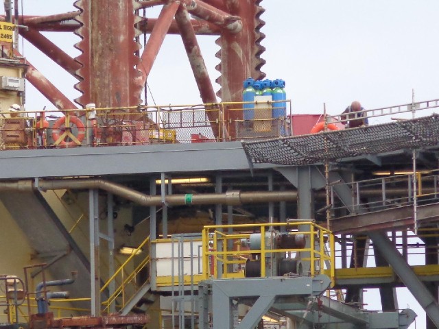 A detail of the platform. There is a man working in the top right.
