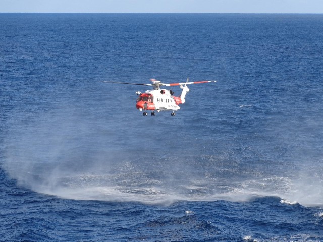The helicopter kicking up sea spray.