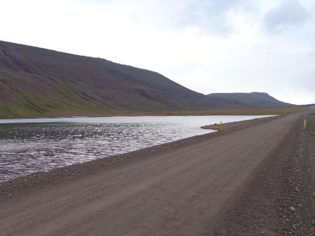 The road passing a lake.