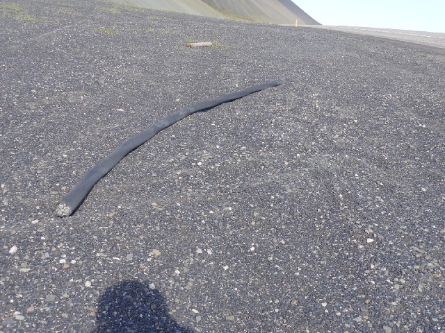 This giant cable was lying on the stones. For scale, the shadow of my helmet is at the bottom of the...