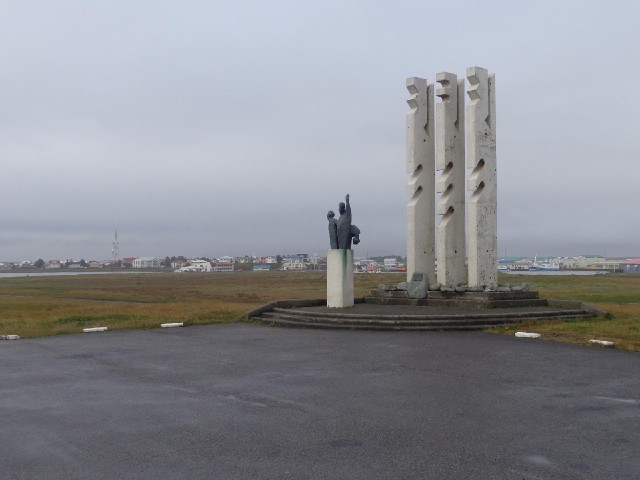 A monument, with the town in the distance.