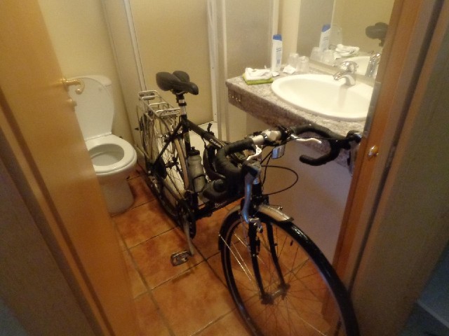 It's raining so hard that I've brought my bike into my cabin....