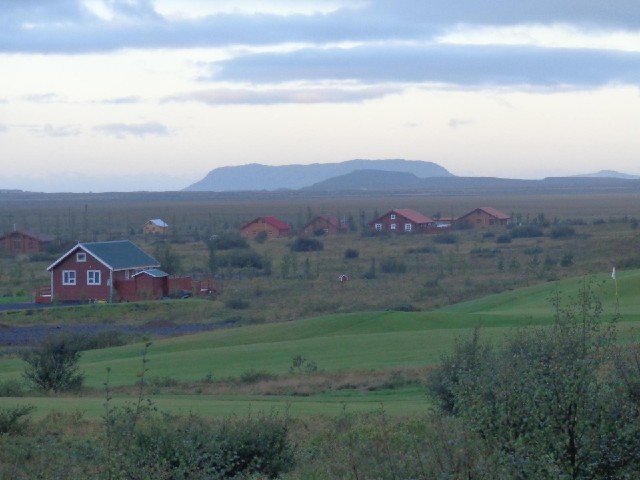 The buildings look typically Icelandic but there's a golf course in the foreground.