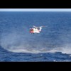The helicopter kicking up sea spray.