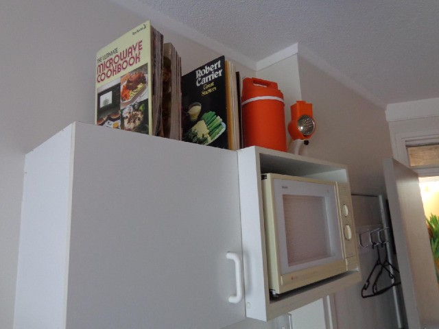 These two books come with the room, as do the orange items next to them, which are a thermos contain...