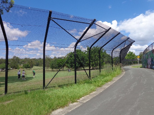 A fence to keep golf balls off the path.