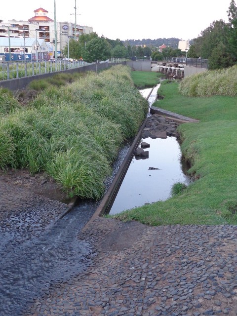 Just a little drainage channel, which passes under a wooden railway bridge in the distance.