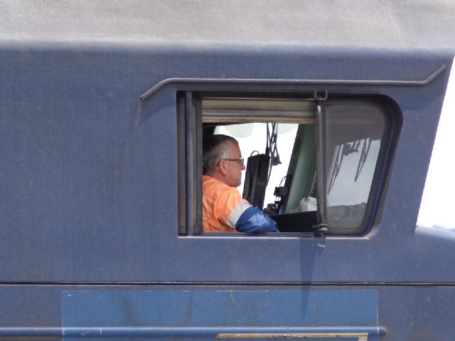 The driver of a passing coal train.