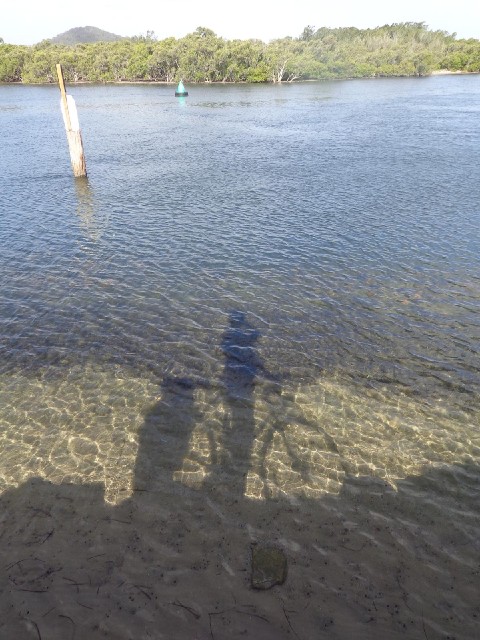 The water here is so clear that I can see my shadow on the bottom.