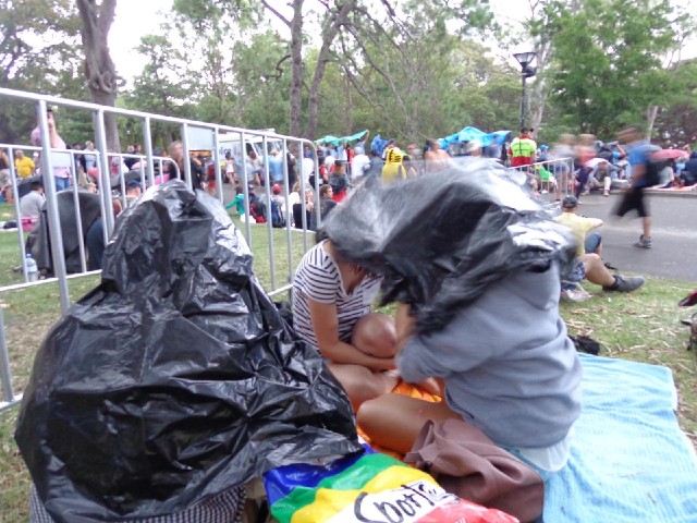 A brief light rain shower had made people suddenly try to find things to shelter under, such as bin ...