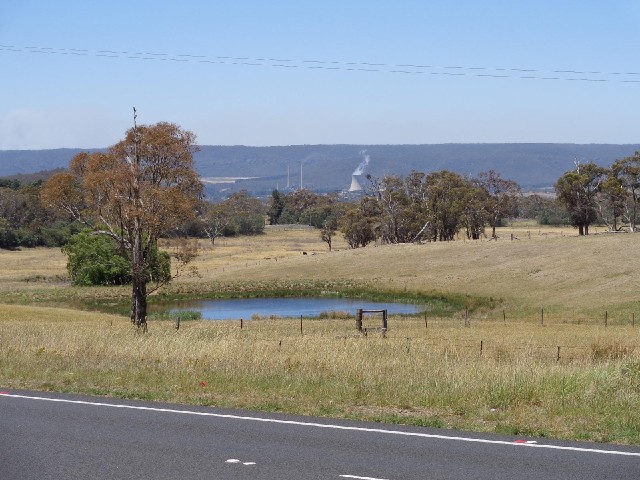 A view with a pond and a power station.
