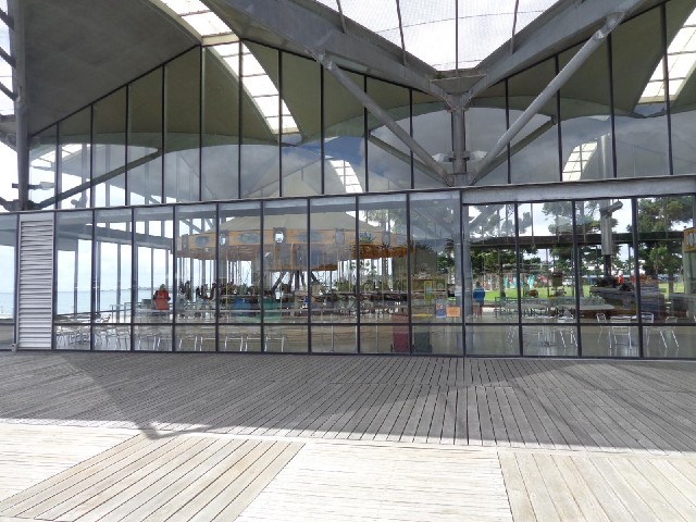 A carousel inside a building by the harbour.