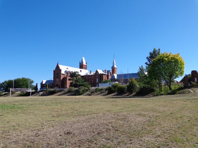 Saint Stanislaus College, and one of the goalposts of an Aussie Rules field.