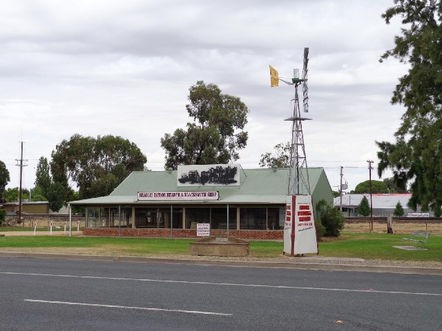 The wind pump here is an advertisement for a company called Aussie Windmill Repairs. The building be...