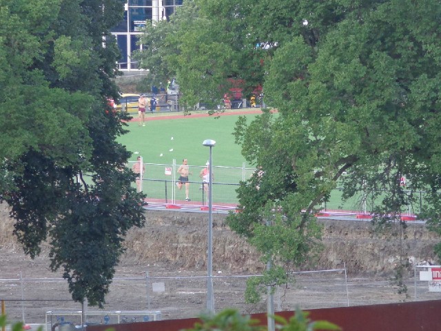 Runners in one of the sports grounds across the river.