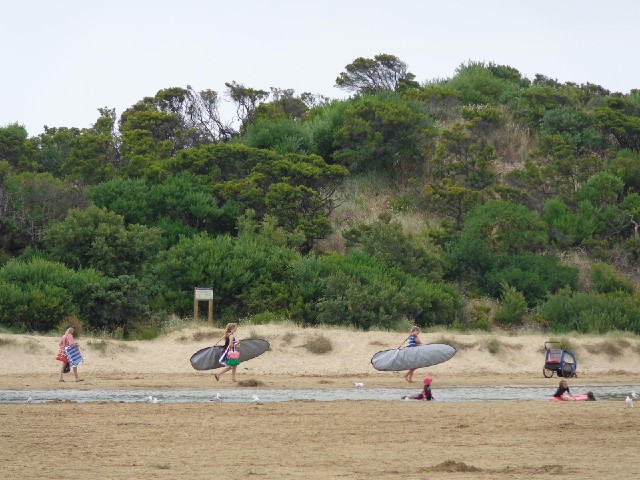 Surfers going to the beach.